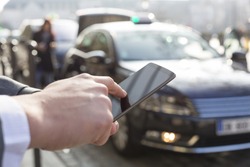 Man orders a taxi from his cell phone. Close-up hands