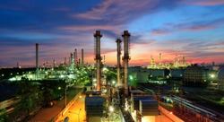 Oil refinery plant at night, The petroleum energy and petrochemical factory with column drum and pipeline construction. Gas, diesel and chemical production business industry is important for economy.