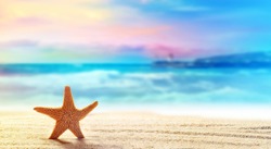 Summer beach with a starfish on a background of the tropical ocean and the beautiful sky