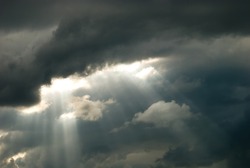 Rays of light shining through dark clouds