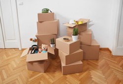 Cardboard boxes with belongings in a room