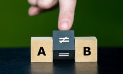 Symbol  that A does not equal B. Hand turns cube and changes the equation 'A equal to B' to 'A unequal to B'.