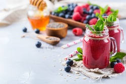 Food and drink, healthy lifestyle, diet and nutrition concept. Mixed smoothie for breakfast with berries, blueberry, raspberry, chia seeds, almond and oat vegan milk. Copy space background