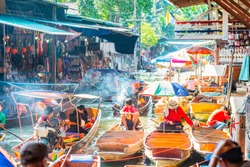 Damnoen Saduak Floating Market, tourists visiting by boat, located in Bangkok, Thailand.