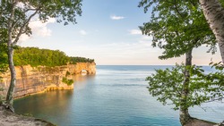 Grand Portal Point catches morning sunshine, in Pictured Rocks National Lakeshore, on Lake Superior, near Munising, Michigan.