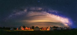 Under the bright Milky Way, Mongolia yurts on the grassland are scattered.	
