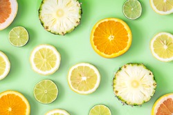 Collection of fresh lime, lemon, orange, citrus, grapefruit, pineapple slice on green background. 