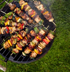 Grilled skewers on a grilled plate, top view, outdoor