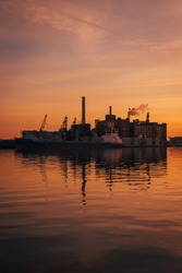 Sunset over Domino Sugars Factory from Fells Point, in Baltimore, Maryland