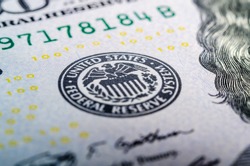 Federal reserve system symbol on hundred dollar bill closeup macro shot