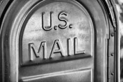 US Mail written on a mailbox.