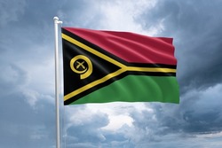 Vanuatu flag on a flagpole waving in the wind on a cloudy sky background. Flag of Vanuatu