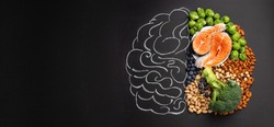Chalk hand drawn brain picture with assorted food for brain health and good memory: fresh salmon, vegetables, nuts, berries on black background. Foods to boost brain power, top view, copy space

