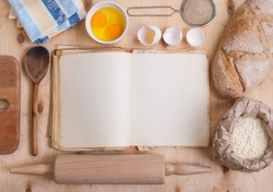 Baking background with blank cook book, eggshell, flour, rolling pin. Free space for text