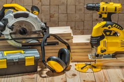 construction carpentry electric hand tools on wooden background