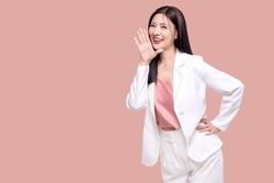 Beauty Asian woman with open mouths raising hands shouting good news isolated on pink background.