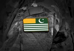 Flag of Azad Kashmir on soldiers arm. Flag of Azad Jammu and Kashmir on military uniform (collage).
