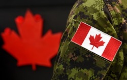 Flag of Canada on the military uniform and red Maple leaf on the background. Canadian soldiers. Army of Canada. Remembrance Day. Poppy day. Canada Day.
