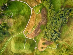 Flat lay, aerial top view of medieval hillfort mounds in Kernave, historical capital city of Lithuania (Sirvintos district). Kernave Archaeological Site is included into UNESCO world heritage list.