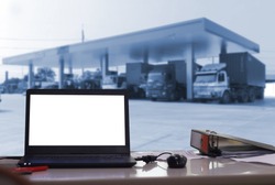 computer copy space for business success and oil or gas  station with trucks background 