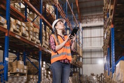 Logistic concept,Female staff checking stock inventory at warehouse or distribution center