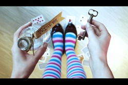Alice in wonderland. Background. Key and potion in hands against a floor