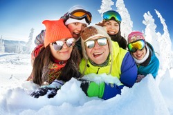 Group of happy friends having fun. Snowbarders and skiers group team friendship. Sheregeshs ski resort
