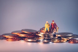 Miniature people, elderly people sitting on stack coins using as job retirement and insurance concept