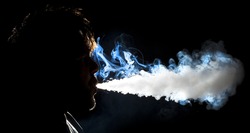 Man blowing vapor cloud from an E-Cigarette