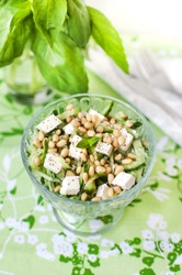 Salad with cucumbers, feta cheese and pine nuts