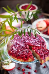Cranberry upside-down cake on rustic background