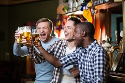 Happy men with beer in pub