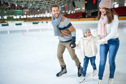 Smiling family at ice-skating rink