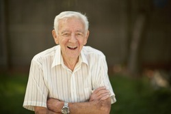 Laughing 90 year old senior elder man outside