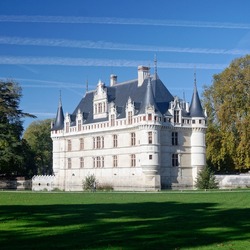 A beautiful view of the famous french castle of Azay-le-Rideau surrounded by a lawn, during a sunny autumn afternoon