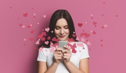 Valentine day concept, love mail - hearts flying out smartphone in womans hands