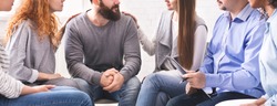 Rehab group meeting. Women comforting stressed man at support therapy, panorama