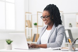 African American Businesswoman Using Laptop In Modern Office. Copy Space