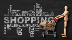 Shopping Conceptual Wordcloud With Wooden Man And Buyer's Shopper Cart Over Black Chalkboard Background. Panorama