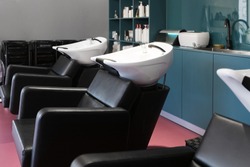 Modern bright hair and beauty salon. Pink and blue interior with workplaces and modern equipment, luxury decor.