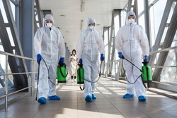 Specialist in hazmat suits cleaning disinfecting coronavirus cells epidemic, pandemic health risk