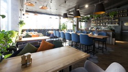 Cozy cafe interior with sofas and tables for quick lunch, angle view, panorama, copy space