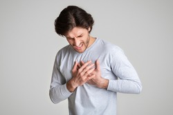 Healthcare concept. Man suffering from chest pain with painful expression