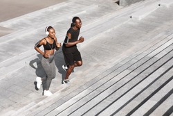 Black Man And Woman Jogging Together In Urban Park, Running Up Steps, Working Out Outdoors, Empty Space