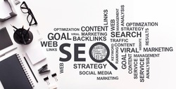 Seo-Optimization Wordcloud With Seo Keywords And Internet Terms Over White Office Desk Background. Online Business, Search Engine Optimization And Web Technologies Concept. Panorama, Collage