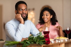 Bad Date. African American Couple Having Unsuccessful Blind Date In Restaurant, Funny Disappointed Shoked Black Man Feeling Embarrassment Listening To Excited Woman Talking