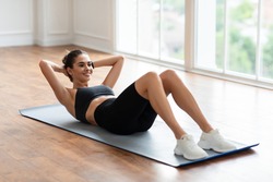 Healthcare, Physical Activity And Sports. Fit Young Lady Exercising At Fitness Club Studio Or Living Room Doing Sit-Ups Crunches Exercise Indoors Lying On Yoga Mat, Training Abdominal Muscles