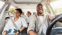 Happy African American Family Riding Car Traveling By Automobile. Black Parents And Daughter Enjoying Summer Road Trip Together On Weekend. Panorama, Selective Focus
