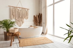 Bathing Room Interior Design. Cozy Empty Modern Bathroom Background With White Bathtub And Panoramic Windows, Rustic Decorations And Green Plants Indoors