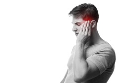 Sad young european guy suffering from headache, press hand to head, monochrome photo and temple highlighted in red, isolated on white background. First signs of illness, migraine, health problems